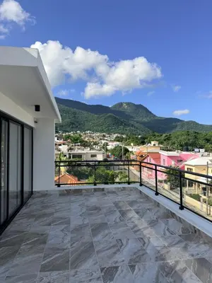 a balcony with a view of a city at PF Hotel in San Felipe de Puerto Plata
