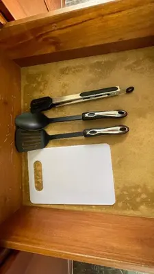 a group of utensils sitting on a wooden shelf at Hideaway Studio - steps from Playa Encuentro at Cabarete in Cabarete