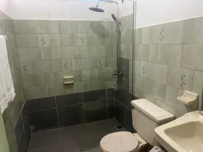 a bathroom with a shower with a toilet and a sink at FredyGreenHouse in Santiago de los Caballeros
