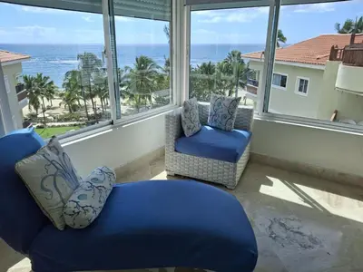 a living room with a view of the ocean at Apartment facing the Caribbean Sea, Juan Dolio Beach in Juan Dolio