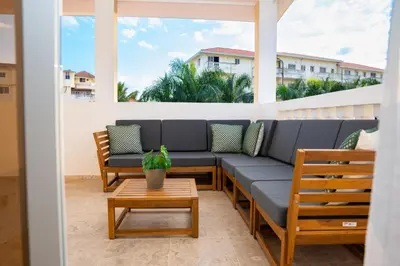 a patio with a couch and a table at Star Villa Boca Chica in Boca Chica