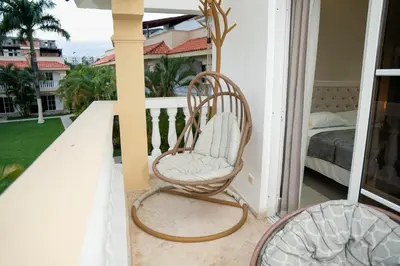 a porch with a rocking chair and a bed at Star Villa Boca Chica in Boca Chica