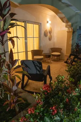 a living room with a chair and some plants at Star Villa Boca Chica in Boca Chica