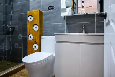 a bathroom with a white toilet and a sink at Spacious Family Home with Sea & Mountain Views in Puerto Plata in San Felipe de Puerto Plata