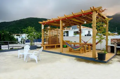 a pavilion with a hammock and a table and chairs at Spacious Family Home with Sea & Mountain Views in Puerto Plata in San Felipe de Puerto Plata