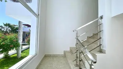 a staircase in a house with a large window at 3BR Hideaway Lux Villa With Pool & beach Access At Playa Encuentro, Cabarete in Cabarete