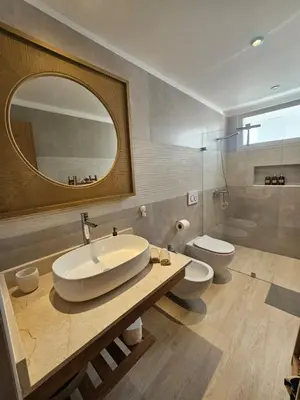 a bathroom with a sink and a toilet and a mirror at Estrella Garden Antlia 201 Modern Apartment in La Laguna