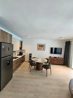 a kitchen and dining room with a table and chairs at Estrella Garden Antlia 201 Modern Apartment in La Laguna