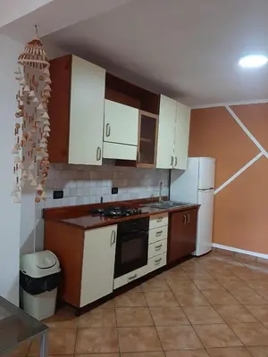 a kitchen with white cabinets and a white refrigerator at Palm Beach Resort in Boca Chica