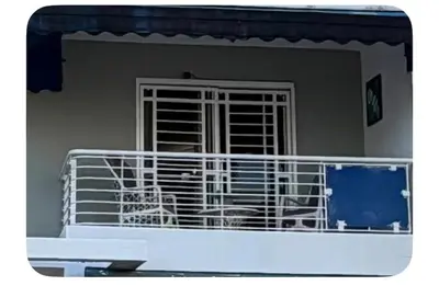 a dog sitting in a cage in a room at Filadelfia II in La Grúa