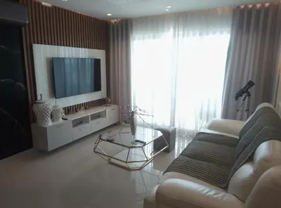 a living room with a couch and a television at Torre Sky 01 M10-2 in Santo Domingo