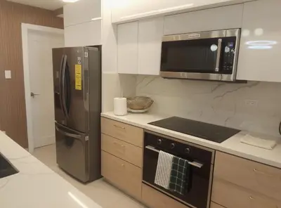 a kitchen with a stainless steel refrigerator and a microwave at Torre Sky 01 M10-2 in Santo Domingo