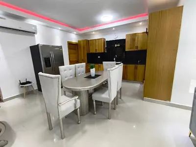 a dining room with a table and white chairs at América Colares VII in Los Frailes