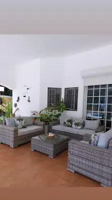 a living room with couches and potted plants at Villa can canet in Nizao