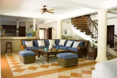 a living room with a blue couch and a table at Villa can canet in Nizao