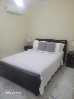a bedroom with a large bed with white sheets and pillows at Bienvenido a casa in San Pedro de Macorís