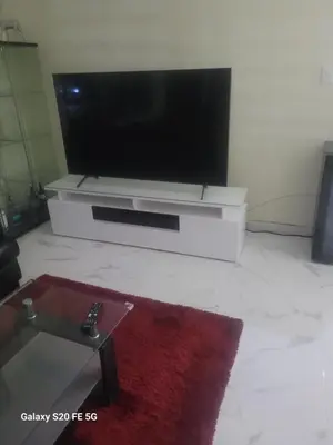 a living room with a flat screen tv and a red rug at Bienvenido a casa in San Pedro de Macorís