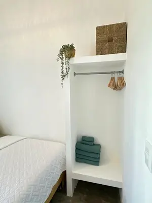 a bedroom with a bed and a shelf with towels at Villa Turquesa En Dreams House - 5 pax, 2 min de la playa in Las Galeras