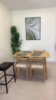 a wooden table and two chairs in a room at Modern Penthouse Style Apt in Licey al Medio