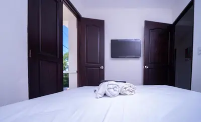 a bedroom with a bed with towels on it at Hotel Porto Escondido in Santa Bárbara de Samaná