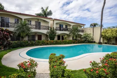 a house with a swimming pool in front of it at Las Terranas Dream Condo in Las Terrenas