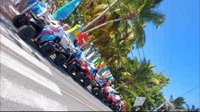 a group of people watching a monster truck parade at Las Terranas Dream Condo in Las Terrenas