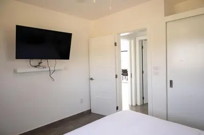 a bedroom with a bed with a tv on the wall at Bonita Extravaganza 4 Bedroom, 4 Bed, 3 Bedroom in Sosúa