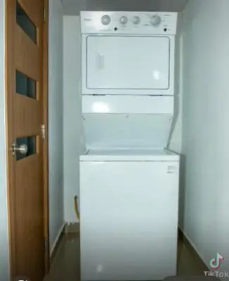 a white stove top oven sitting on top of a refrigerator at Residencial Mediterraneo III in Santiago de los Caballeros