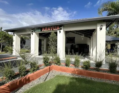 a building with a lawn in front of it at Villa Anaylia