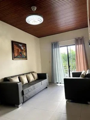 a living room with a couch and a window at Villa Anaylia