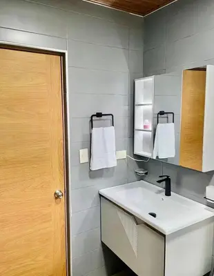 a bathroom with a white sink and a mirror at Villa Anaylia