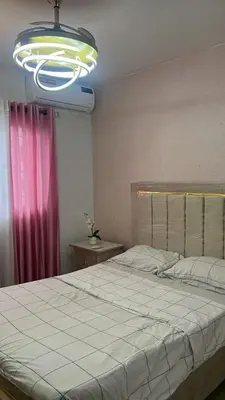 a bedroom with a large bed and a light at Seguro y completo in Peralejo