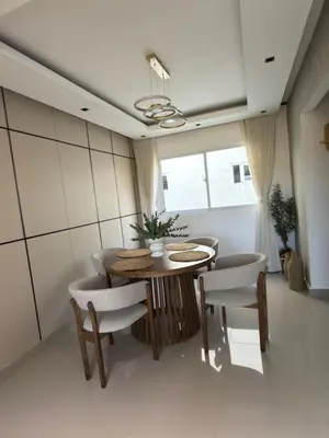 a dining room with a table and chairs at spectrum stay in Baní