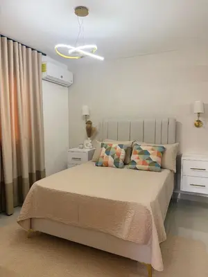 a bedroom with a bed and a ceiling at spectrum stay in Baní