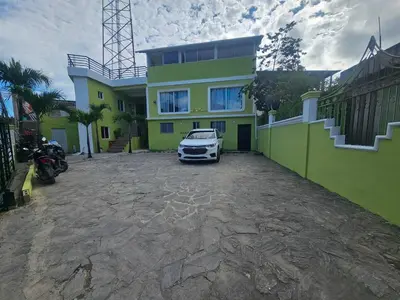 a car parked in front of a house at W&W Hotel in Las Terrenas