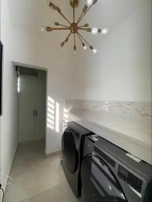 a washer and dryer in a room with a ceiling at Luxury Caribbean Oasis in La Romana