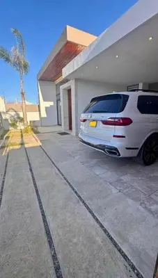 a white car parked in front of a house at Luxury Caribbean Oasis in La Romana