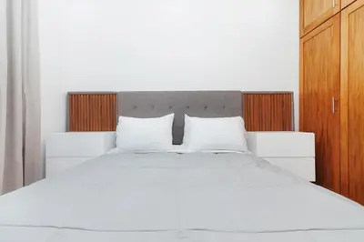 a white bed with two pillows in a bedroom at Exclusive Top-Floor Penthouse with Jacuzzi - BlueCasas in Santiago de los Caballeros