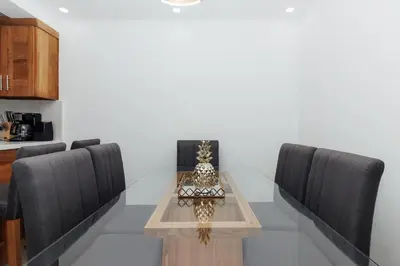 a dining room table with two chairs and a tableasteryasteryasteryasteryasteryastery at Exclusive Top-Floor Penthouse with Jacuzzi - BlueCasas in Santiago de los Caballeros