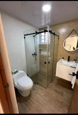 a bathroom with a shower and a toilet and a sink at Condominio Esperanza B102 in San Pedro de Macorís