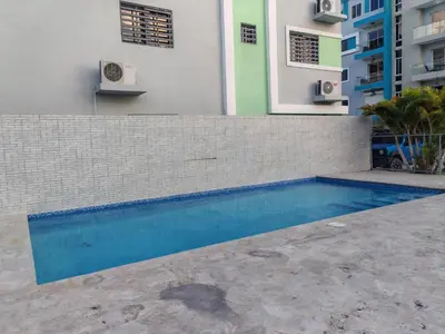 a swimming pool in front of a building at Condominio Esperanza B102 in San Pedro de Macorís