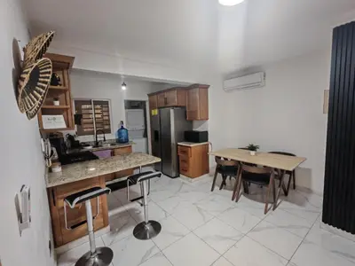 a kitchen with a table and a dining room at Condominio Esperanza B102 in San Pedro de Macorís