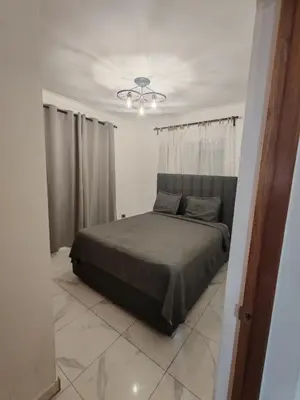 a bedroom with a bed and a ceiling fan at Condominio Esperanza B102 in San Pedro de Macorís