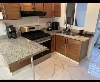 a kitchen with a stove and a sink at Condominio Esperanza B102 in San Pedro de Macorís