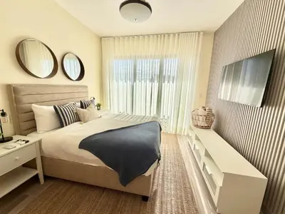a bedroom with a bed and a large window at Modern 1B 5 min to CapCana Beach in Las Terrenas