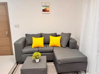 a living room with a gray couch with yellow pillows at Ocean View Fast Wifi Close to Everything Coffee 2BR in La Cana