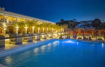 a large swimming pool in a building with palm trees at Ocean reset in Sosúa