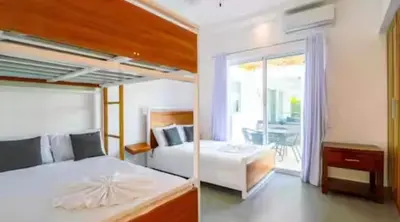 a bedroom with two beds and a balcony at Ocean reset in Sosúa