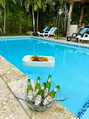 a tray of beer bottles in a basket next to a swimming pool at Ocean reset in Sosúa