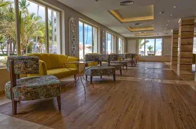 a waiting room with chairs and tables and windows at Majestic Mirage Punta Cana, All Suites – All Inclusive in Punta Cana